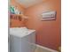 Bright laundry room with washer, dryer, and shelving at 15404 Trinity Fall Way, Bradenton, FL 34212
