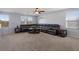 Spacious living room with a large sectional sofa and carpet flooring at 15404 Trinity Fall Way, Bradenton, FL 34212