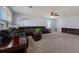 Spacious living room with sectional sofa, fireplace, and ceiling fan at 15404 Trinity Fall Way, Bradenton, FL 34212