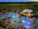 Aerial view of resort pool at night with lighting at 16415 Isola Pl, Bradenton, FL 34211