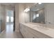 Double vanity bathroom with large mirror and view of bedroom at 16415 Isola Pl, Bradenton, FL 34211