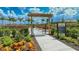 Entrance to community garden with arbor and flowers at 16415 Isola Pl, Bradenton, FL 34211