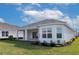Charming house exterior with covered patio and yard at 16415 Isola Pl, Bradenton, FL 34211