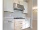 Kitchen features gas cooktop, stainless steel range hood, and white shaker cabinets at 16415 Isola Pl, Bradenton, FL 34211