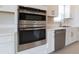Stainless steel double oven and microwave, built into white shaker cabinets at 16415 Isola Pl, Bradenton, FL 34211