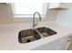 Modern kitchen sink with white cabinets and a sleek faucet at 16415 Isola Pl, Bradenton, FL 34211