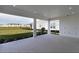 Covered patio overlooking a backyard and pond at 16415 Isola Pl, Bradenton, FL 34211