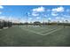 Modern tennis courts with ample lighting and seating at 16415 Isola Pl, Bradenton, FL 34211