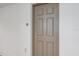 Simple condo entry door with neutral color palette at 1771 Ringling Blvd Blvd # 1009, Sarasota, FL 34236