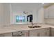 Modern kitchen features a large island with seating, stainless steel appliances, and white cabinetry at 1771 Ringling Blvd Blvd # 1009, Sarasota, FL 34236