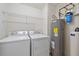 Laundry room with washer, dryer, and extra shelving at 1771 Ringling Blvd Blvd # 1009, Sarasota, FL 34236