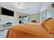 Spacious bedroom with a large bed, TV, and access to a patio at 23039 Worth Ave, Port Charlotte, FL 33954