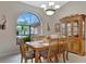 Bright dining room featuring a wood table and hutch with large window at 23039 Worth Ave, Port Charlotte, FL 33954