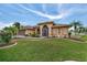Single-story house with well-maintained landscaping and a two-car garage at 23039 Worth Ave, Port Charlotte, FL 33954
