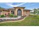 Welcoming front entry with decorative landscaping and walkway at 23039 Worth Ave, Port Charlotte, FL 33954