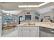 Modern kitchen with white cabinets, granite counters and stainless steel appliances at 23039 Worth Ave, Port Charlotte, FL 33954