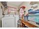 Functional laundry room with washer, dryer, and shelving at 23039 Worth Ave, Port Charlotte, FL 33954