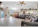Spacious living room with a leather sectional sofa and tile flooring at 23039 Worth Ave, Port Charlotte, FL 33954