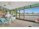 Cozy screened-in porch with casual seating and a view of the backyard at 23039 Worth Ave, Port Charlotte, FL 33954