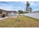 Spacious backyard with patio, modern pergola and plenty of green space at 2430 Sunnyside Ln, Sarasota, FL 34239