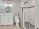 Modern bathroom with a walk-in shower and white cabinetry at 2430 Sunnyside Ln, Sarasota, FL 34239