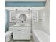 Modern bathroom with white cabinets, marble countertops, and updated fixtures at 2430 Sunnyside Ln, Sarasota, FL 34239