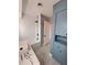 Updated bathroom with soaking tub and blue accents at 2430 Sunnyside Ln, Sarasota, FL 34239