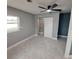 Bright bedroom with ceiling fan and tile floors at 2430 Sunnyside Ln, Sarasota, FL 34239