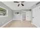 Spacious bedroom with neutral walls, ceiling fan, and tile floors at 2430 Sunnyside Ln, Sarasota, FL 34239