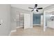 Spacious bedroom with built-in shelving and ceiling fan at 2430 Sunnyside Ln, Sarasota, FL 34239