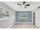 Bright bedroom featuring neutral walls, ceiling fan, and tile floors at 2430 Sunnyside Ln, Sarasota, FL 34239