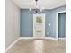 Simple dining area with tile floors and a modern chandelier at 2430 Sunnyside Ln, Sarasota, FL 34239
