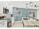Updated kitchen with white cabinets, stainless steel appliances and an island at 2430 Sunnyside Ln, Sarasota, FL 34239