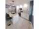 Modern kitchen featuring white shaker cabinets, a large island, and stainless steel appliances at 2430 Sunnyside Ln, Sarasota, FL 34239