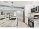 Modern kitchen featuring stainless steel appliances and granite countertops at 2430 Sunnyside Ln, Sarasota, FL 34239