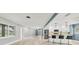 Open floor plan living area with tile flooring and a modern kitchen at 2430 Sunnyside Ln, Sarasota, FL 34239