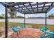 Relaxing patio area with brick pavers and teal chairs at 2430 Sunnyside Ln, Sarasota, FL 34239