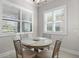 Charming breakfast nook with a round table and four chairs, bathed in sunlight at 26768 Weiskopf Dr, Englewood, FL 34223