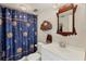 Bathroom with shower/tub combo, vanity, and a celestial-themed shower curtain at 277 Sherwood Dr # 277D, Bradenton, FL 34210