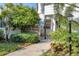 Ground level condo entrance with lush landscaping at 277 Sherwood Dr # 277D, Bradenton, FL 34210