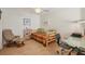 Guest bedroom with daybed, small desk, and adjacent seating area at 277 Sherwood Dr # 277D, Bradenton, FL 34210