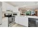 White kitchen cabinets and stainless steel appliances at 277 Sherwood Dr # 277D, Bradenton, FL 34210