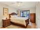 Main bedroom with a comfortable bed, ample closet space, and wood floors at 277 Sherwood Dr # 277D, Bradenton, FL 34210