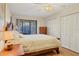 Main bedroom with a queen bed, dresser, and sliding doors to a private balcony at 277 Sherwood Dr # 277D, Bradenton, FL 34210
