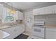 White kitchen with gas range and ample counter space at 2928 Bahia Vista St, Sarasota, FL 34239