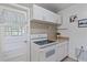 White kitchen with gas range and updated appliances at 2928 Bahia Vista St, Sarasota, FL 34239
