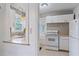 Kitchen with breakfast bar and view into living area at 2928 Bahia Vista St, Sarasota, FL 34239