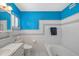 Clean bathroom with teal and white tile and a built-in bathtub at 327 Hernando Ave, Sarasota, FL 34243