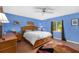 Bedroom with wood furniture, blue walls and ceiling fan at 327 Hernando Ave, Sarasota, FL 34243