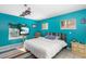 Main bedroom with teal walls, a large bed, and built-in shelving at 327 Hernando Ave, Sarasota, FL 34243